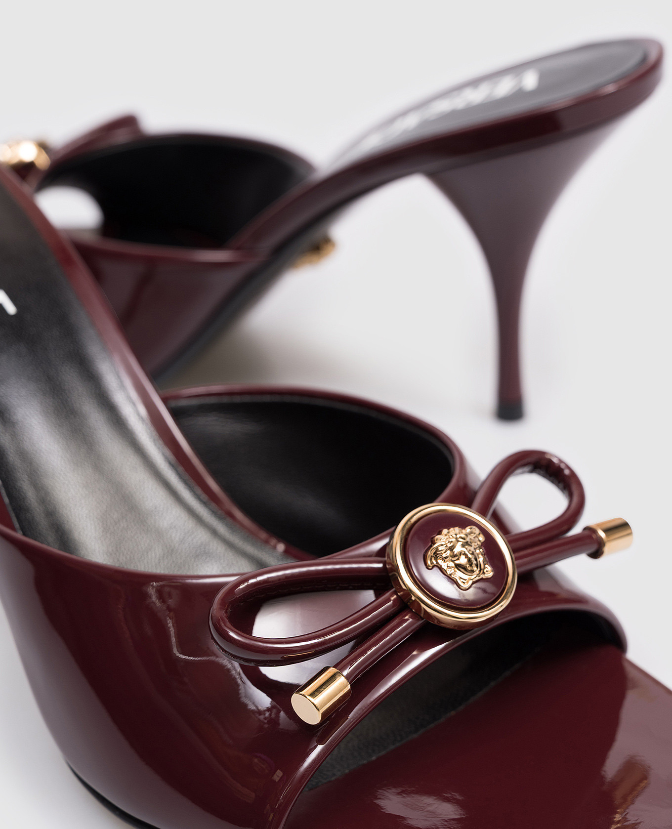 

Opera Bow burgundy patent leather mules Versace