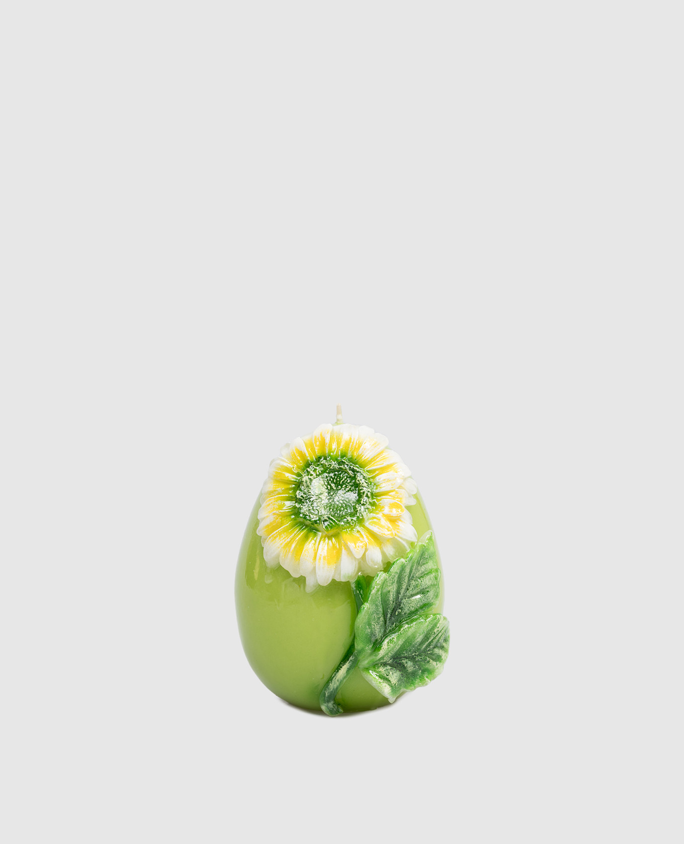 

Green egg-shaped candle with gerbera Cereria Introna