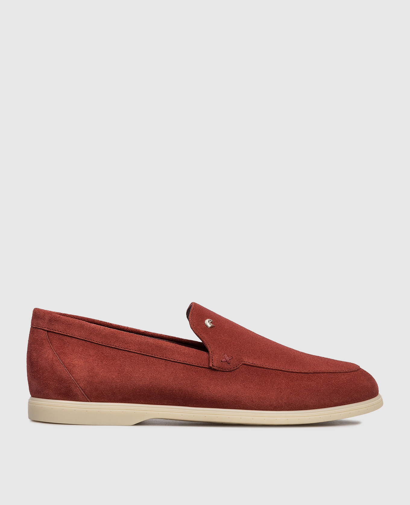 Burgundy suede loafers with textured emblem