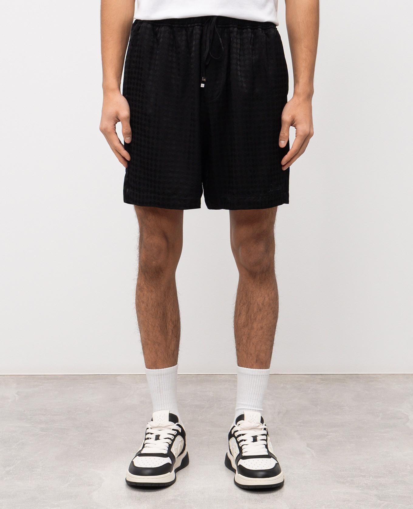 

Black shorts with monogram pattern AMIRI
