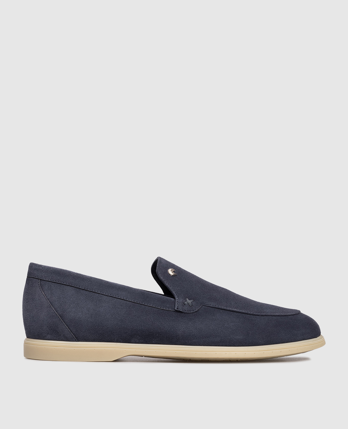 Blue suede loafers with textured emblem