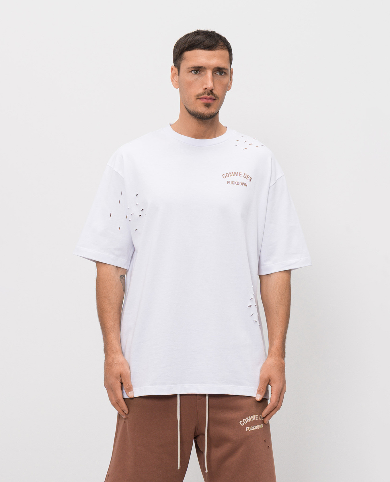 

White T-shirt with logo print and holes Comme des Fuckdown