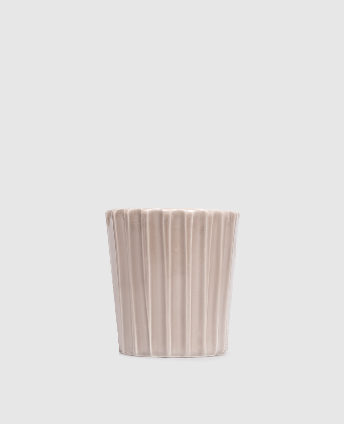 Beige scented candle in a ceramic candle holder
