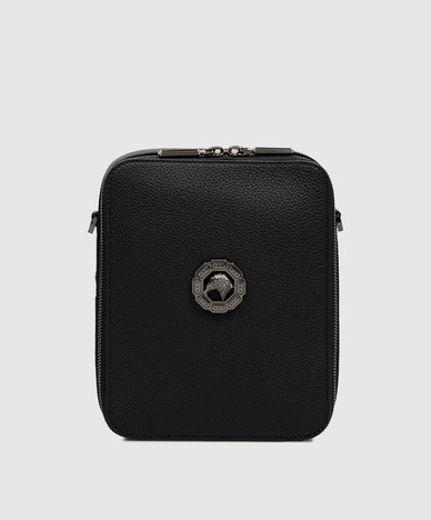 Black leather bag with textured emblem