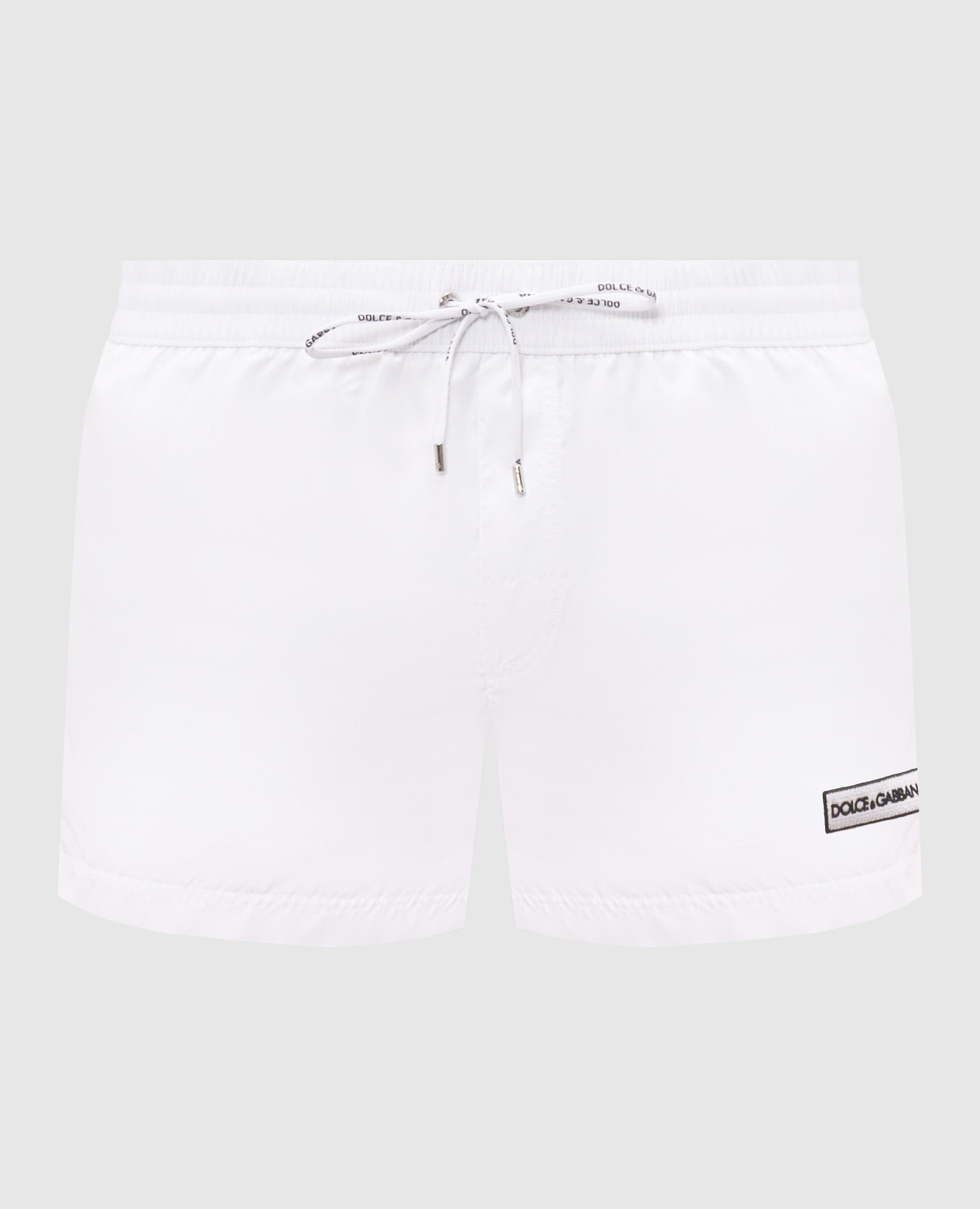 White swim shorts with logo patch