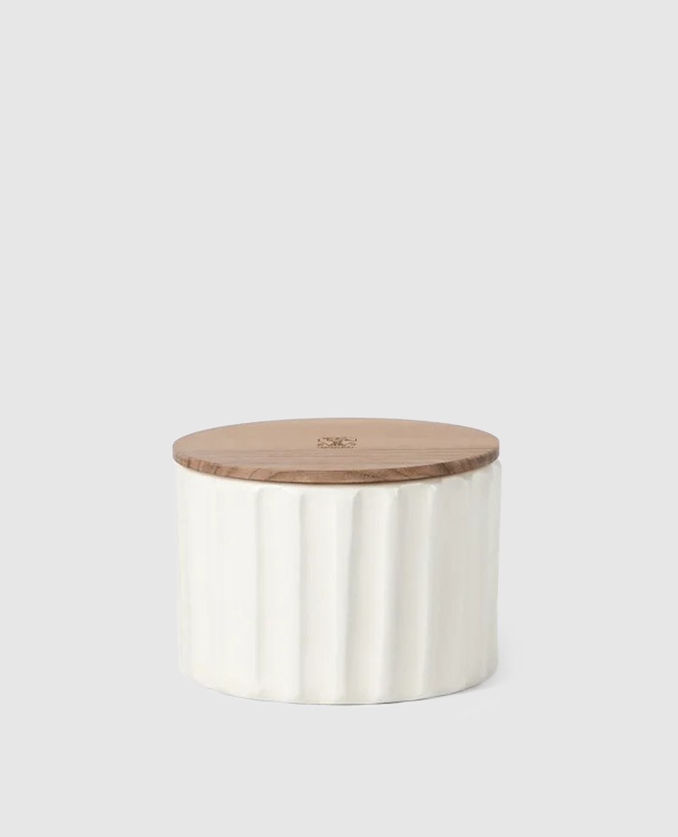 White scented candle in a ceramic candle holder