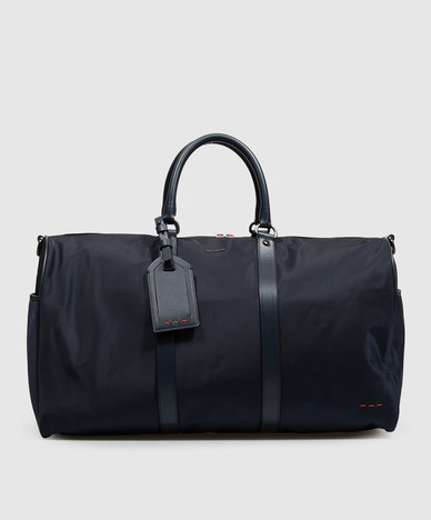 Blue travel bag with metal logo