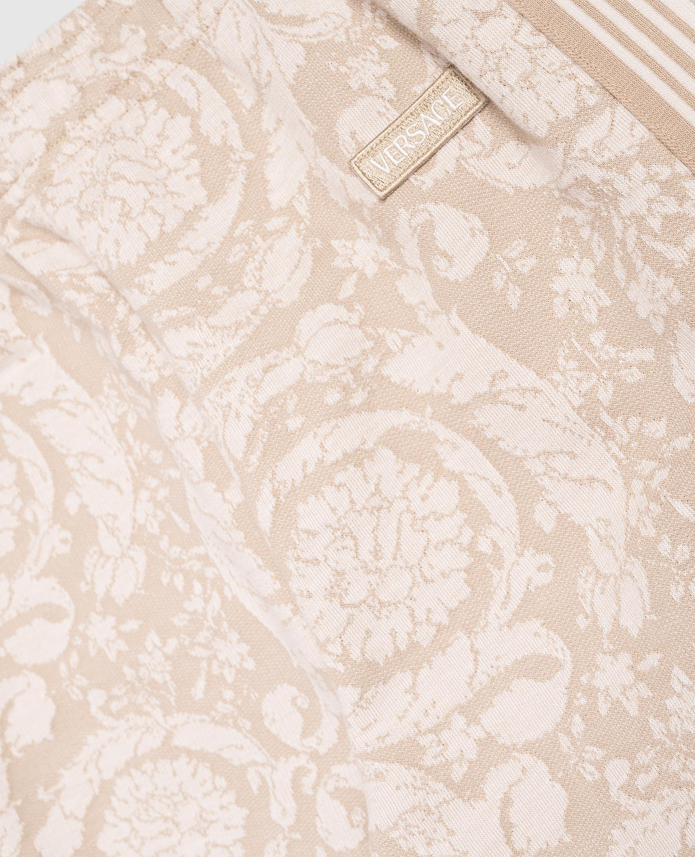 

Children's beige patterned joggers Versace