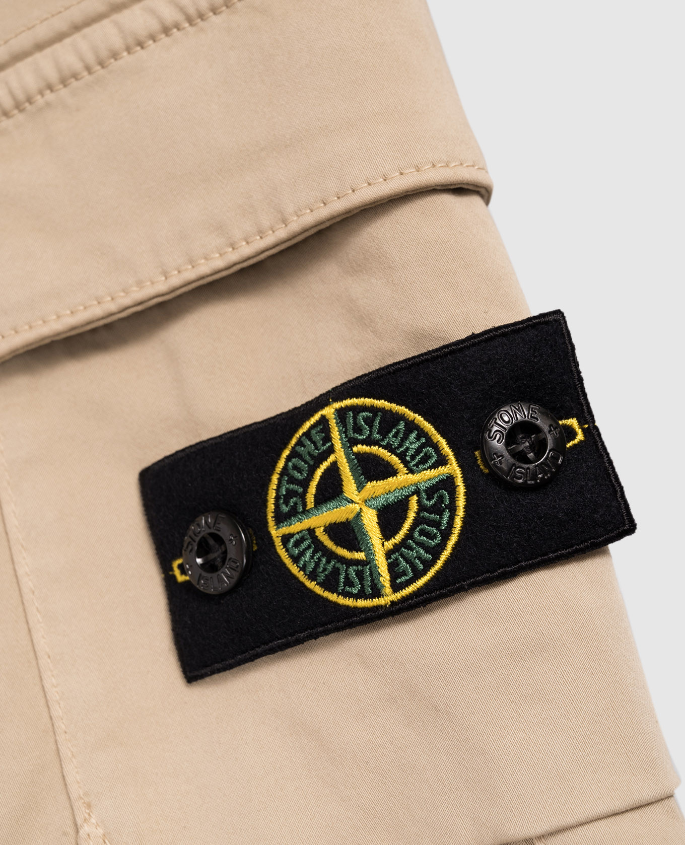 

Children's beige joggers with logo Stone Island